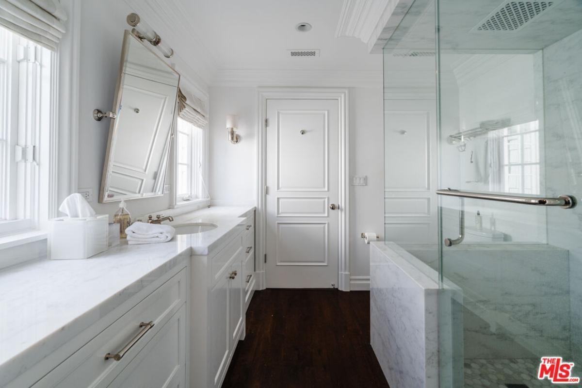 Crisp White Bathroom with Marble and Dark Wood Contrast