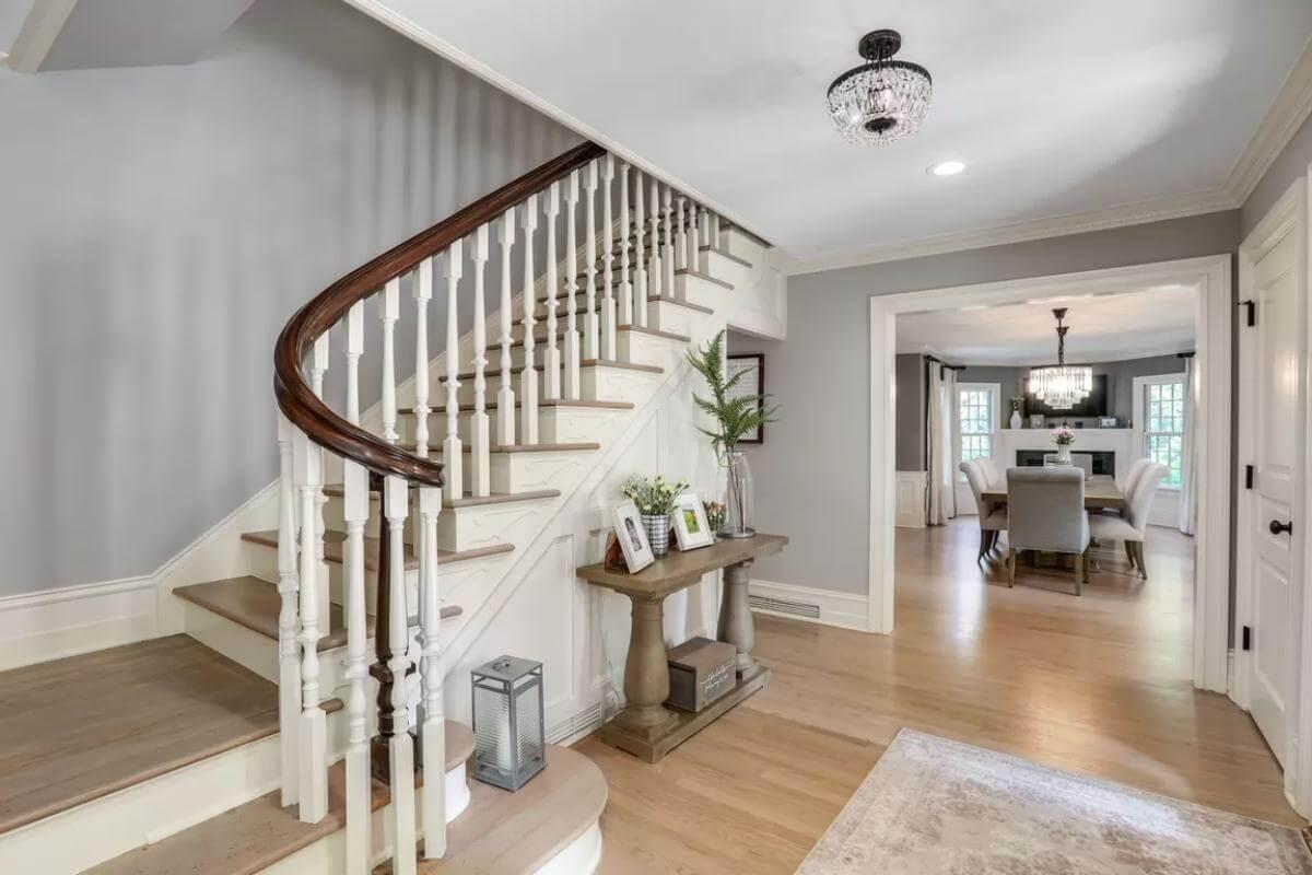 Graceful Stairway with Elegant Banister Leading to a Formal Dining Space