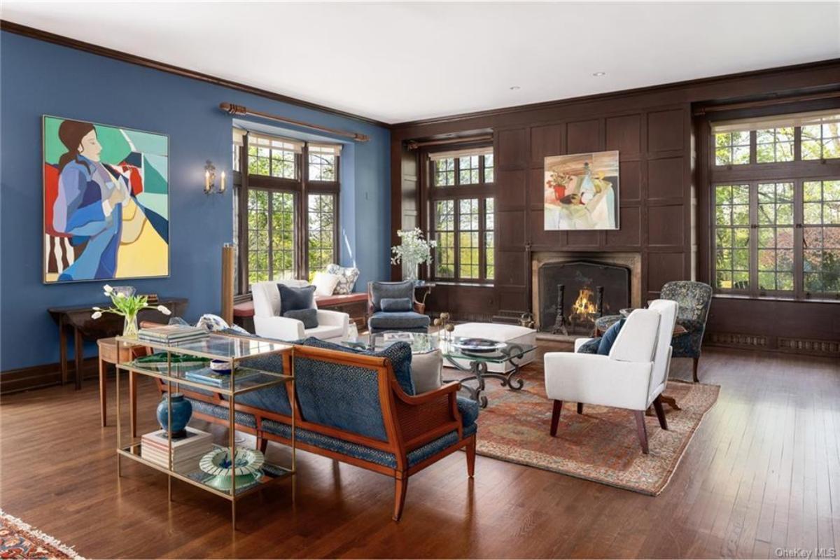 Wow, Look at This Living Room with Rich Wood Paneling and Bold Art