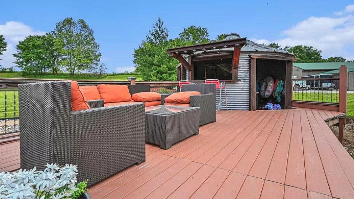 Outdoor Deck with Modern Rattan Seating and Rustic Charms