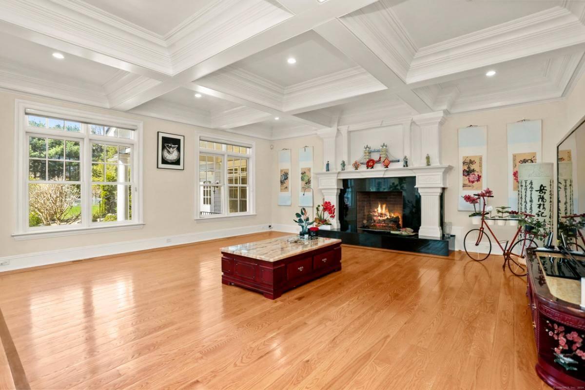Elegant Living Room with a Striking Coffered Ceiling and Fireplace Focal Point