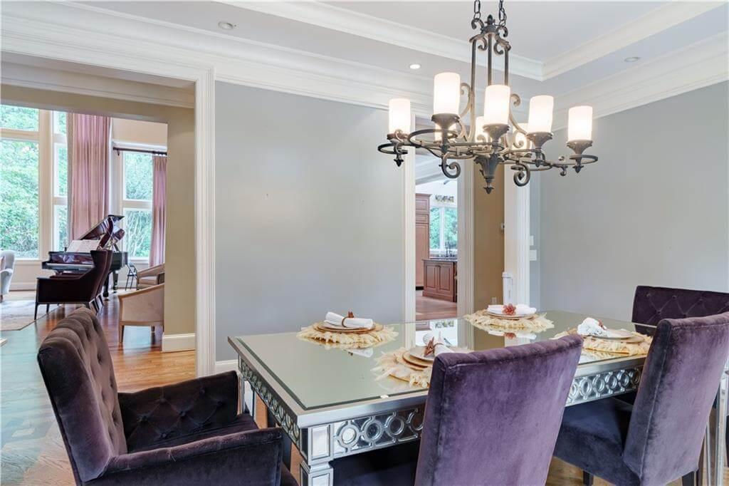 Look at the Ornate Chandelier Highlighting This Sleek Dining Room