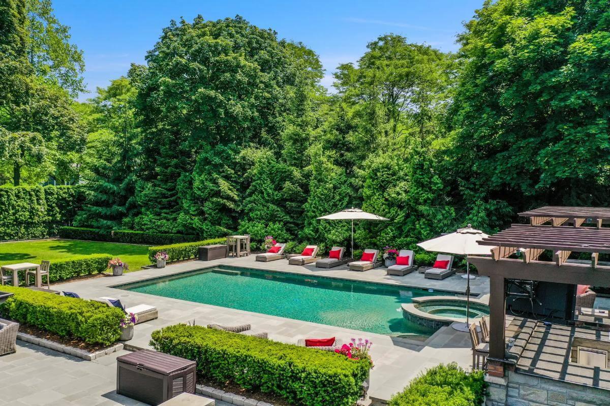 Relax by the Pool with Plush Loungers and a Pergola Retreat