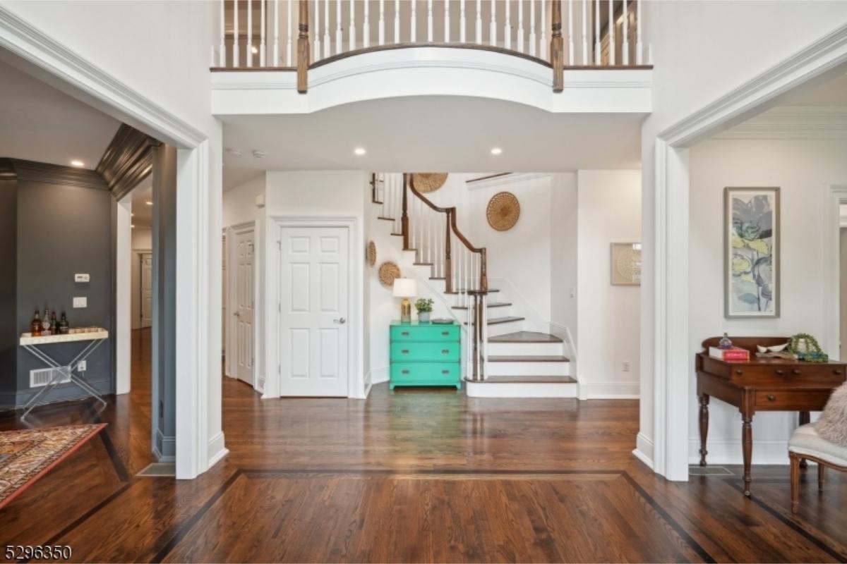 Grand Entryway with Sweeping Staircase and Vibrant Accents