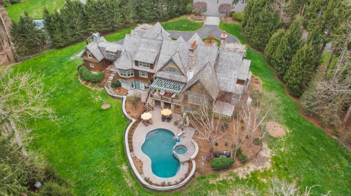 Aerial View of a Craftsman Home with Unique Rooflines and Poolside Oasis