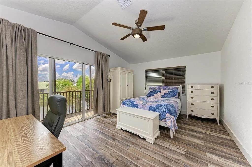 Charming Bedroom with Desk Overlooking Water Views