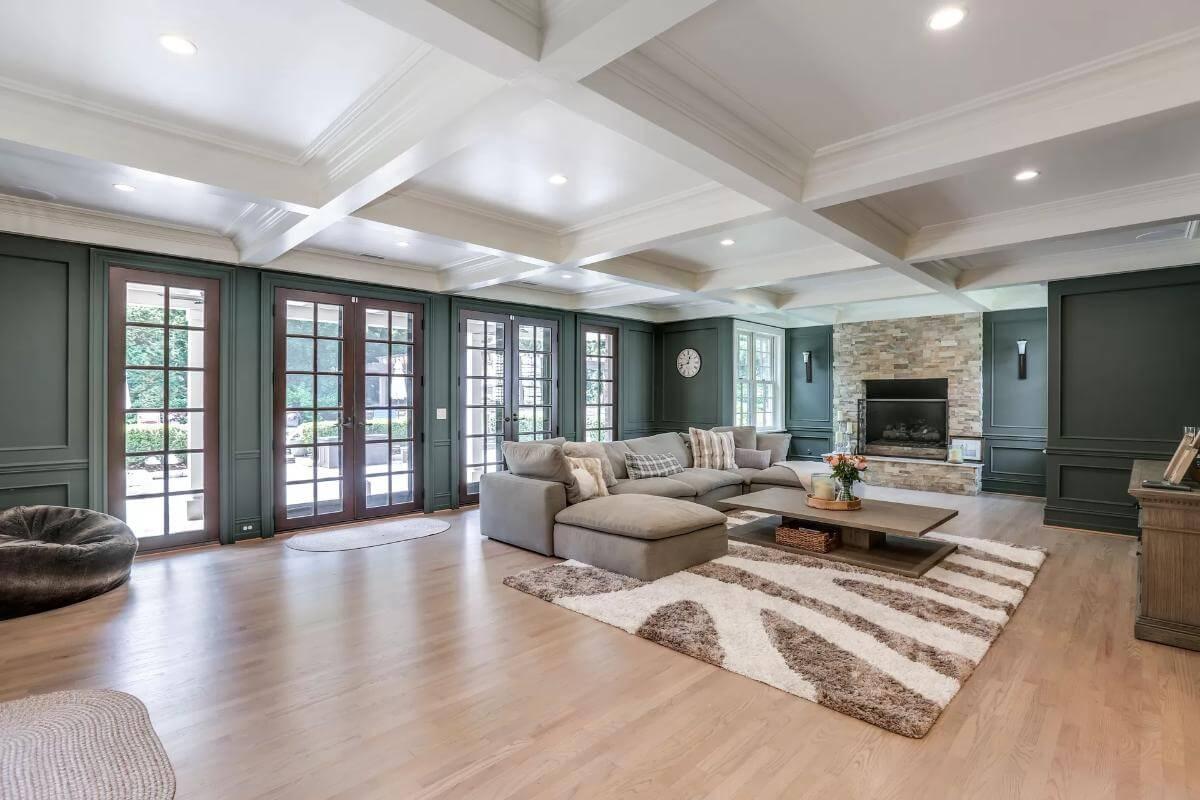 Spacious Living Room with Stone Fireplace and French Doors Galore
