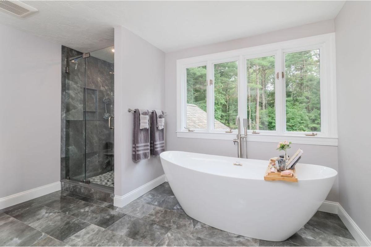 Relax in a Bright Bathroom with a Freestanding Tub and Nature Views