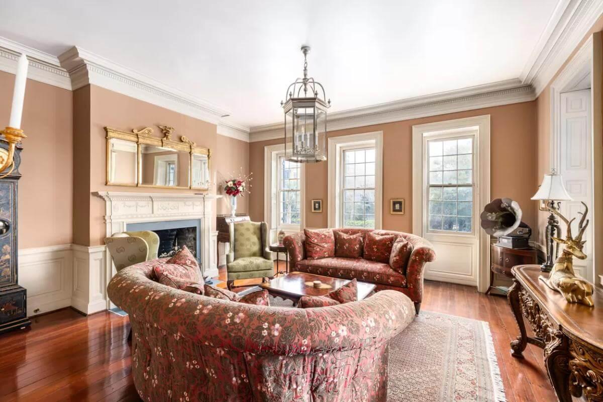 Classic Living Room with Ornate Fireplace and Curved Sofa