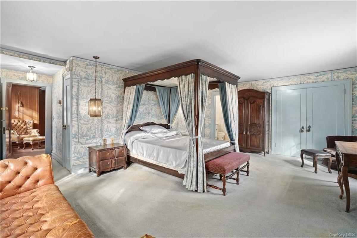 Step into This Vintage Bedroom Featuring a Four-Poster Bed with Drapes