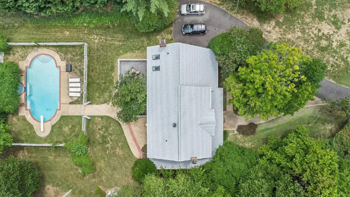 Dive Into the Backyard Oasis Complete with a Pool and Patio