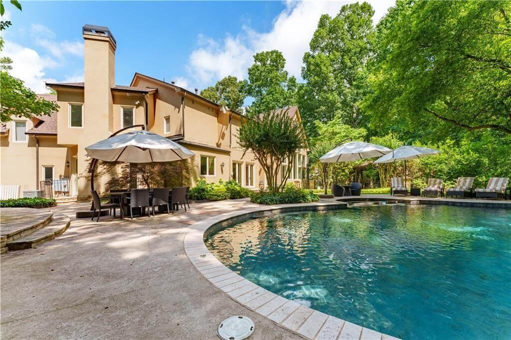 Enjoy the Outdoor Elegance with Poolside Views and Lush Greenery