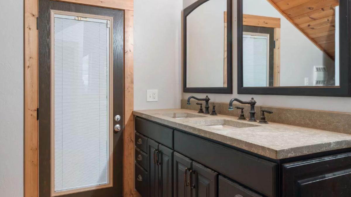 Double Vanity and Natural Wood Accents in a Rustic Bath