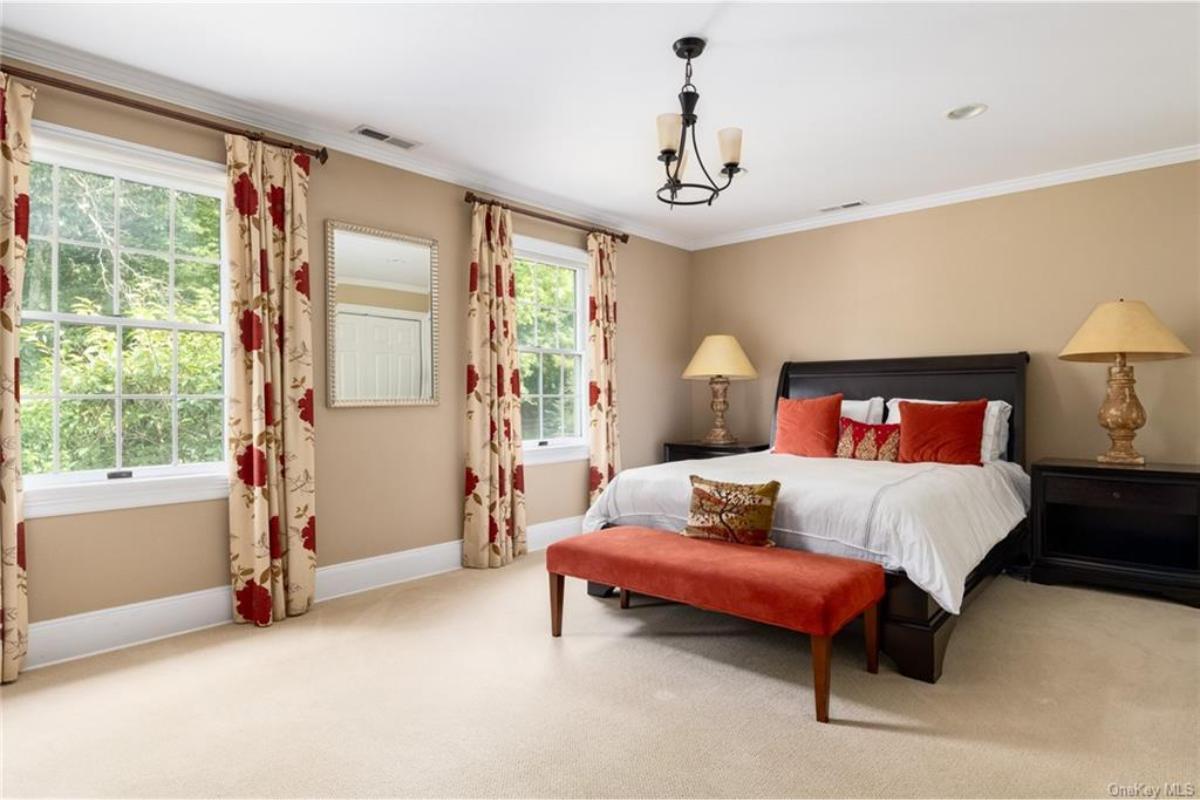 Notice the Bold Red Accents in This Comfortable Bedroom Setting