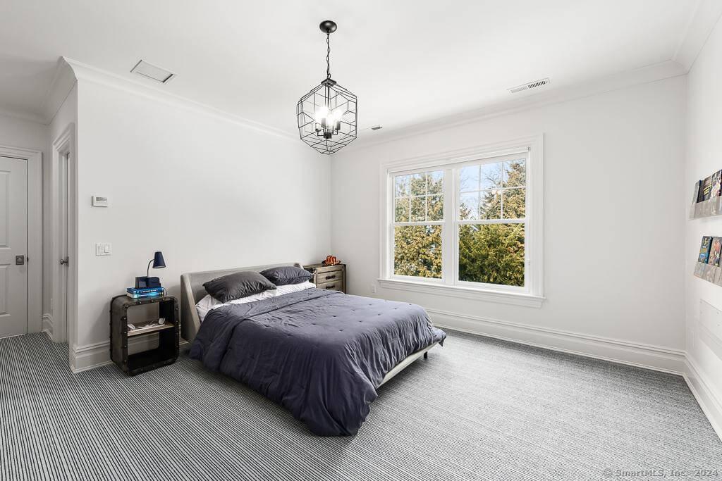 Contemporary Bedroom with Striking Pendant Lighting and Simple Elegance