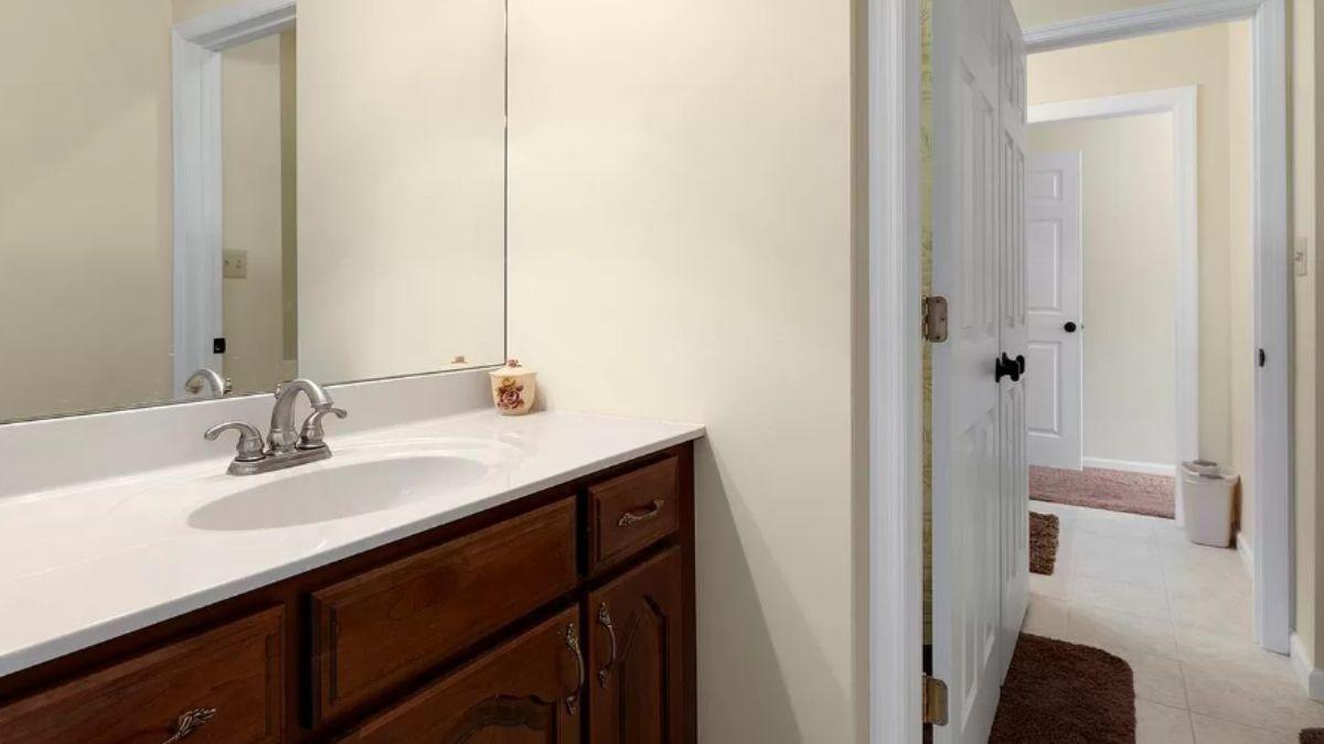 Wood Vanity Pops Against Light Walls in This Bright Bathroom