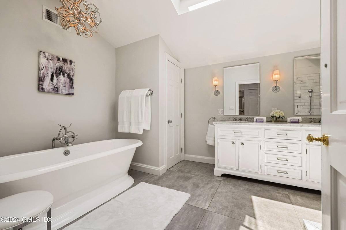 Elegant Bathroom with a Freestanding Tub and Unique Chandelier