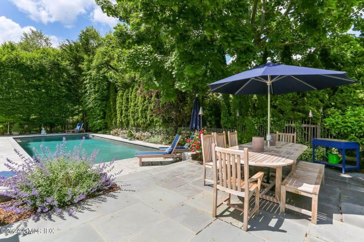 Relaxing Poolside Dining Area with Lush Greenery for a Private Escape
