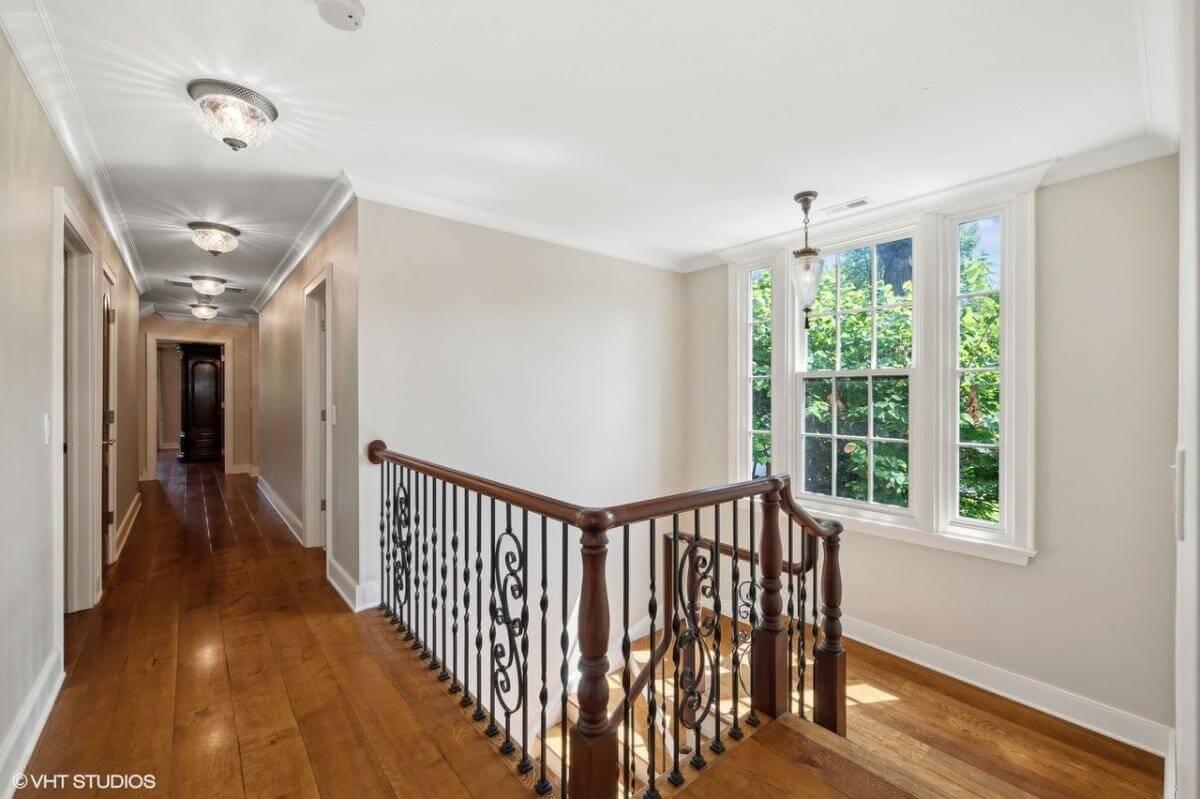 Notice the Sunlit Hallway with Elegant Iron Balustrades