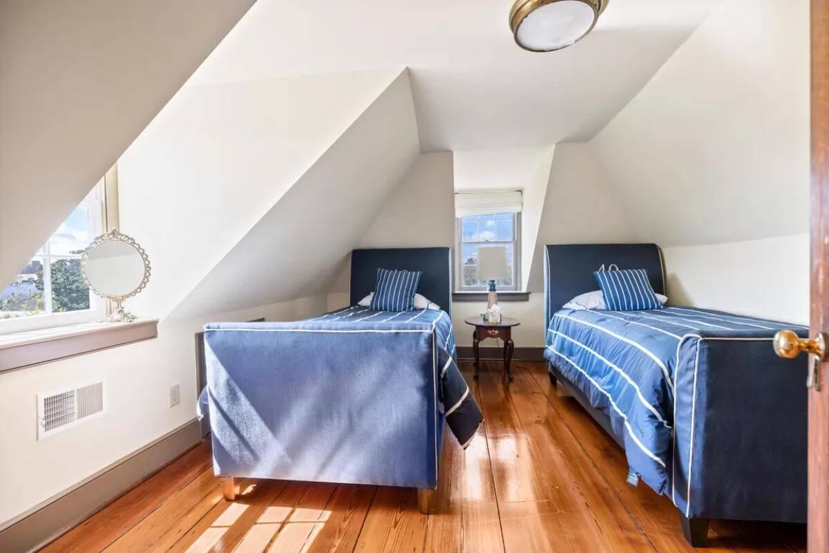Twin Bedroom Retreat with Sloped Ceilings and Nautical Touches