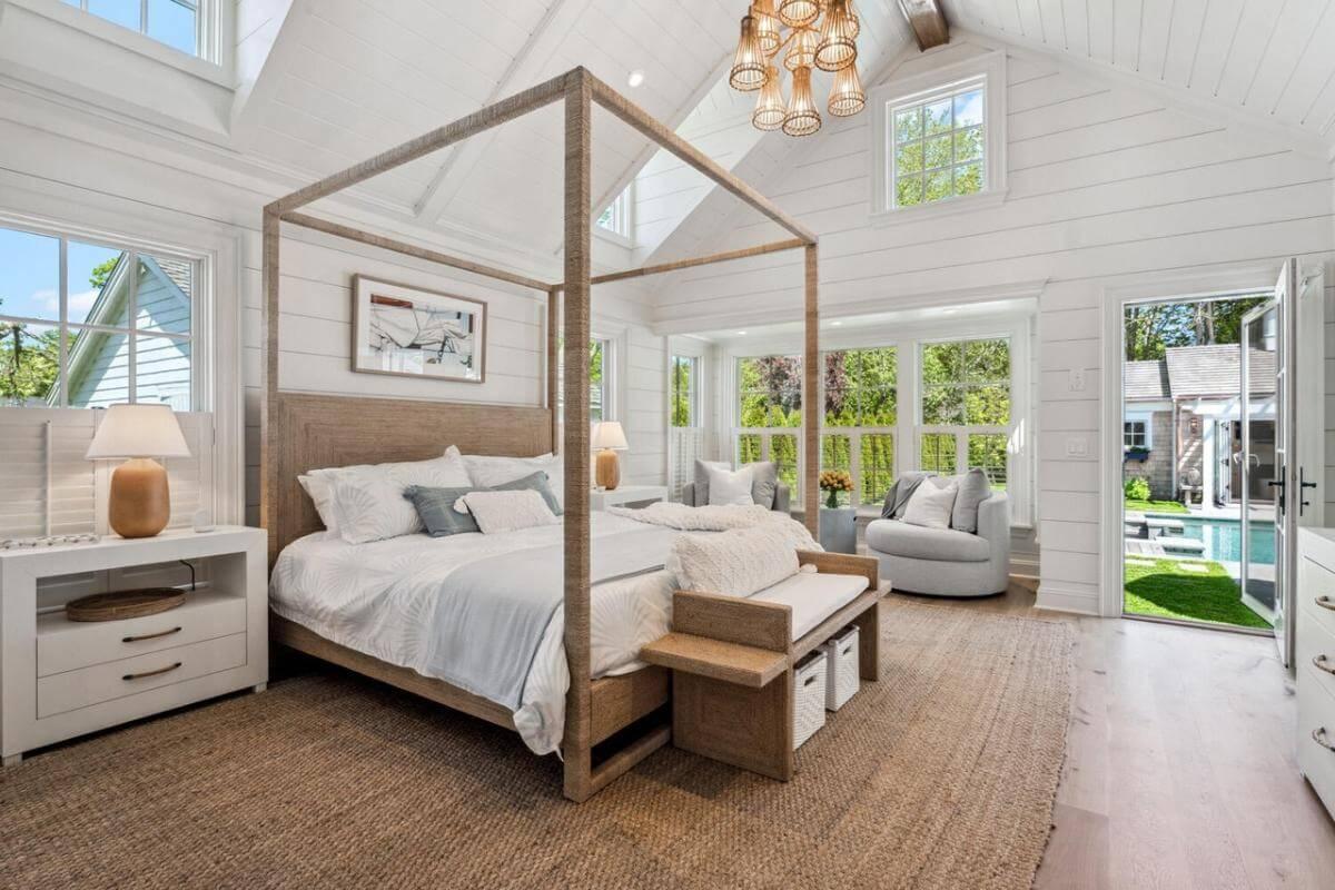 Farmhouse Bedroom with Canopy Bed and Poolside View