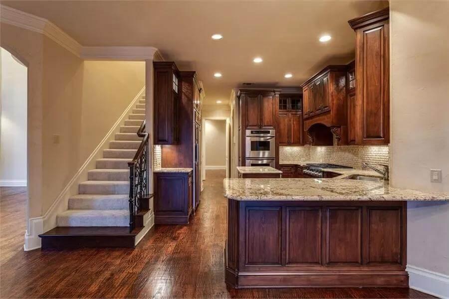 Look at the Dark Wood Elegance in This Kitchen with Granite Accents