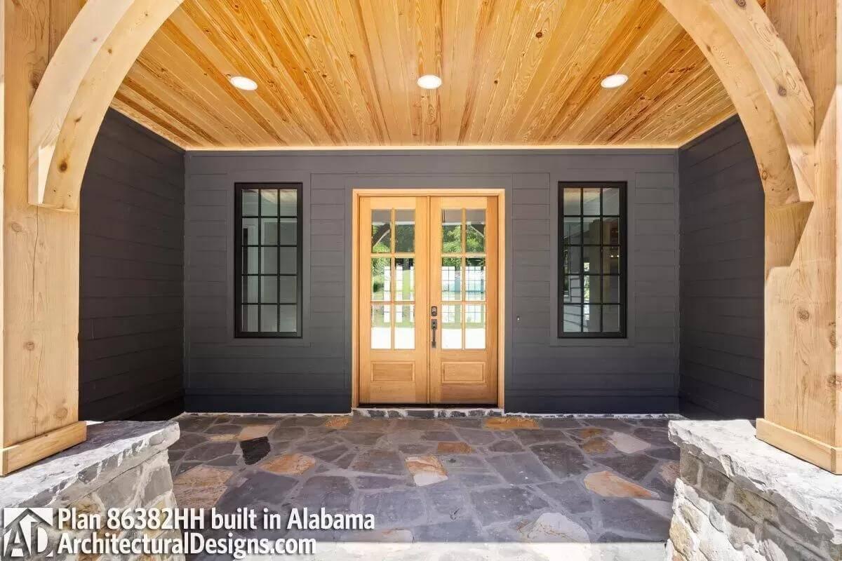 Step Onto This Stone-Tiled Craftsman Porch with Arched Timber Details