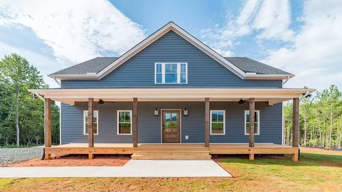 Classic Farmhouse with a Spacious Porch and Bold Blue Siding