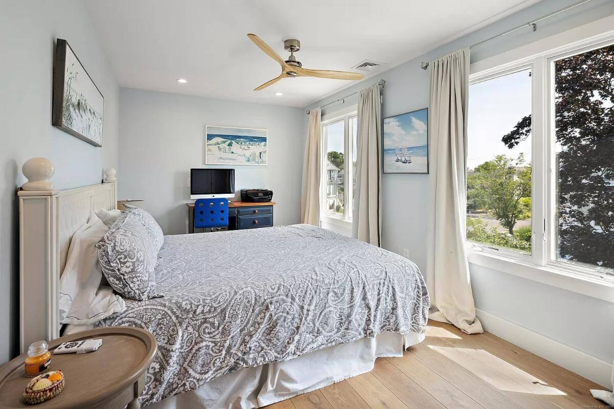 Bright Bedroom with Coastal Art and Scenic Views