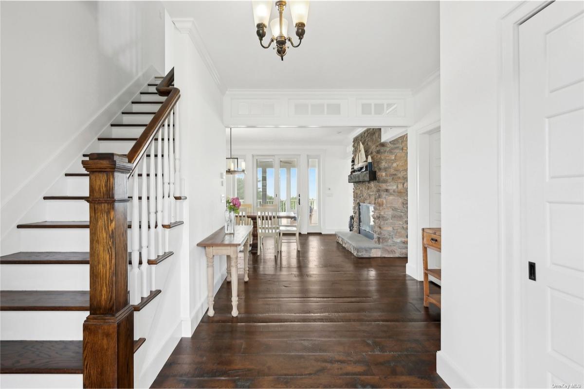 Elegant Entry with Rich Wood Floors and Stonework Charm