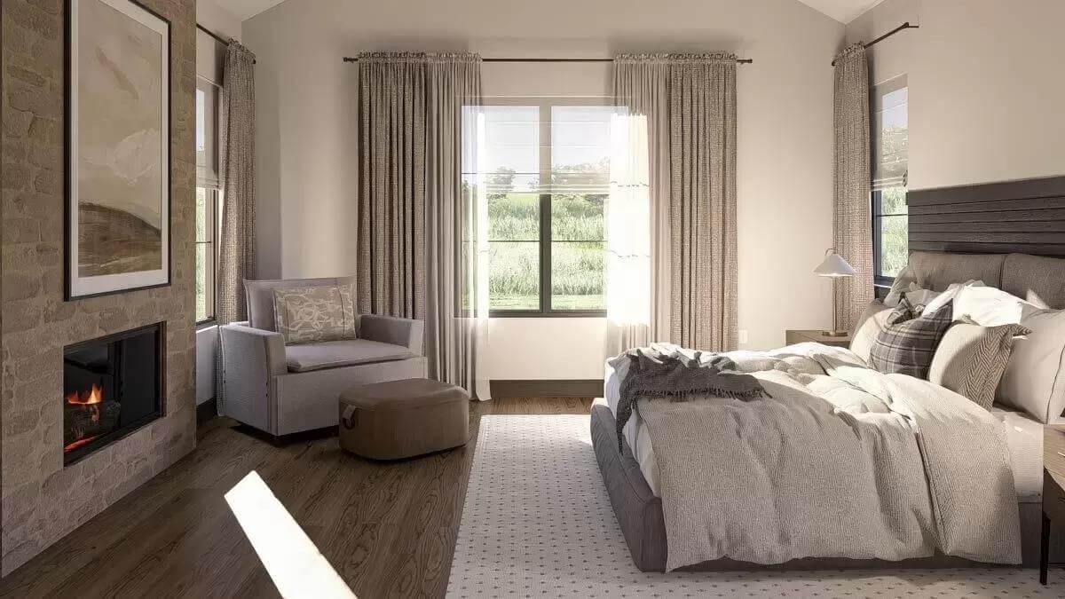Cozy Bedroom with a Stone Fireplace and Sunlit Views