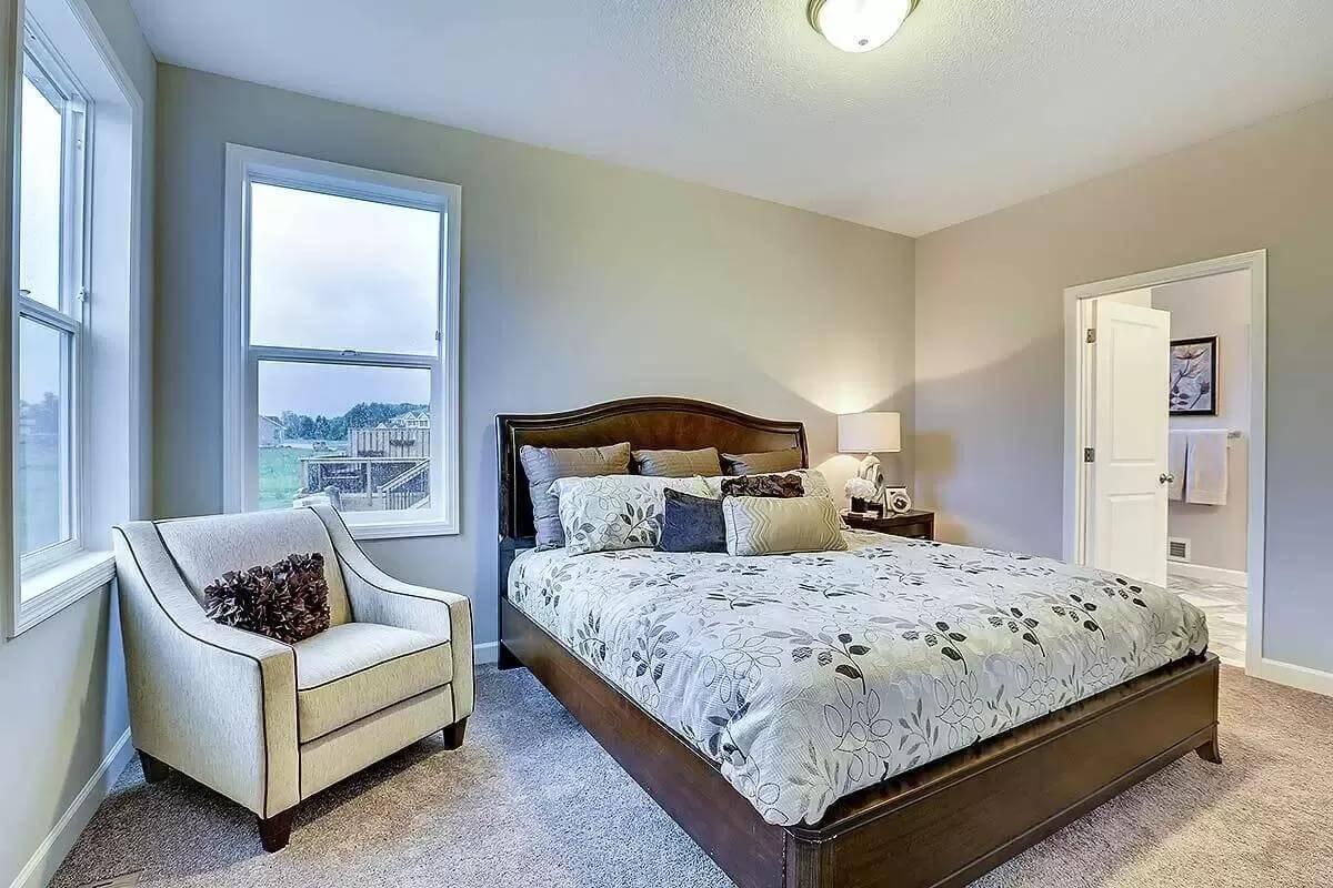 Restful Bedroom Retreat with Classic Upholstered Chair and Scenic Views