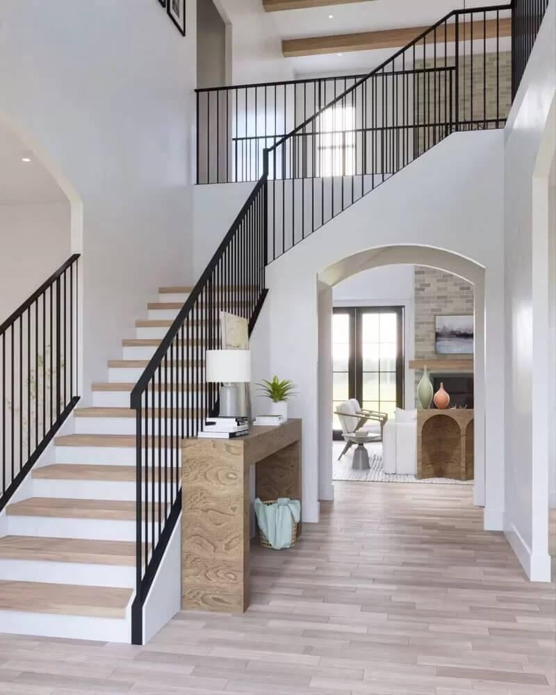 Elegant Staircase Design with Iron Railings and Light Wood Accents