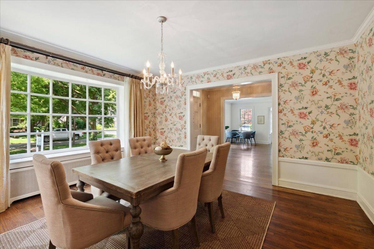 Elegant Dining Room with Floral Walls and a Classic Chandelier