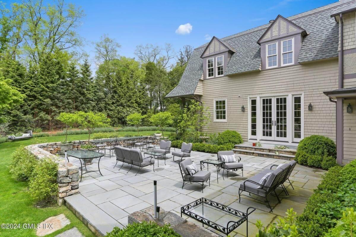 Relax on the Elegant Stone Patio with Classic Wrought Iron Furniture