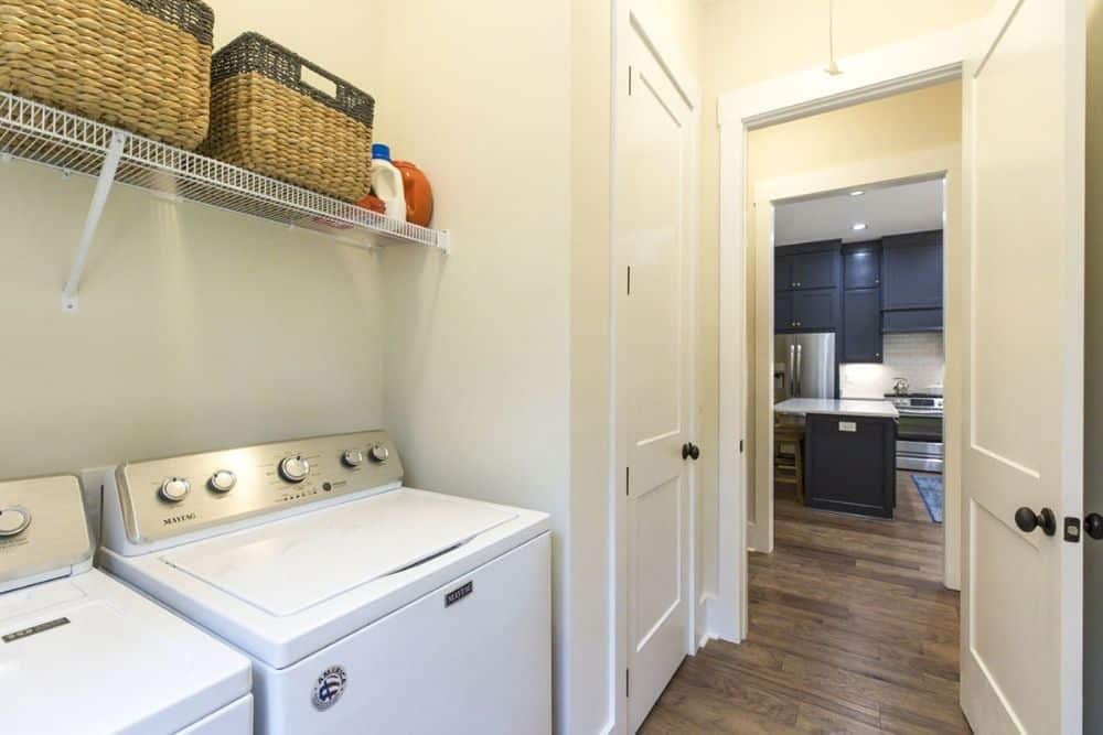Efficient Laundry Space Leads into Bold Craftsman Kitchen