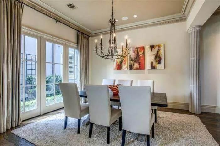 Elegant Dining Room with Classic Pillars and Luxurious Rug