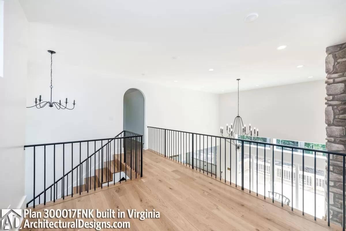 Notice the Elegant Black Railings Framing This Airy Loft