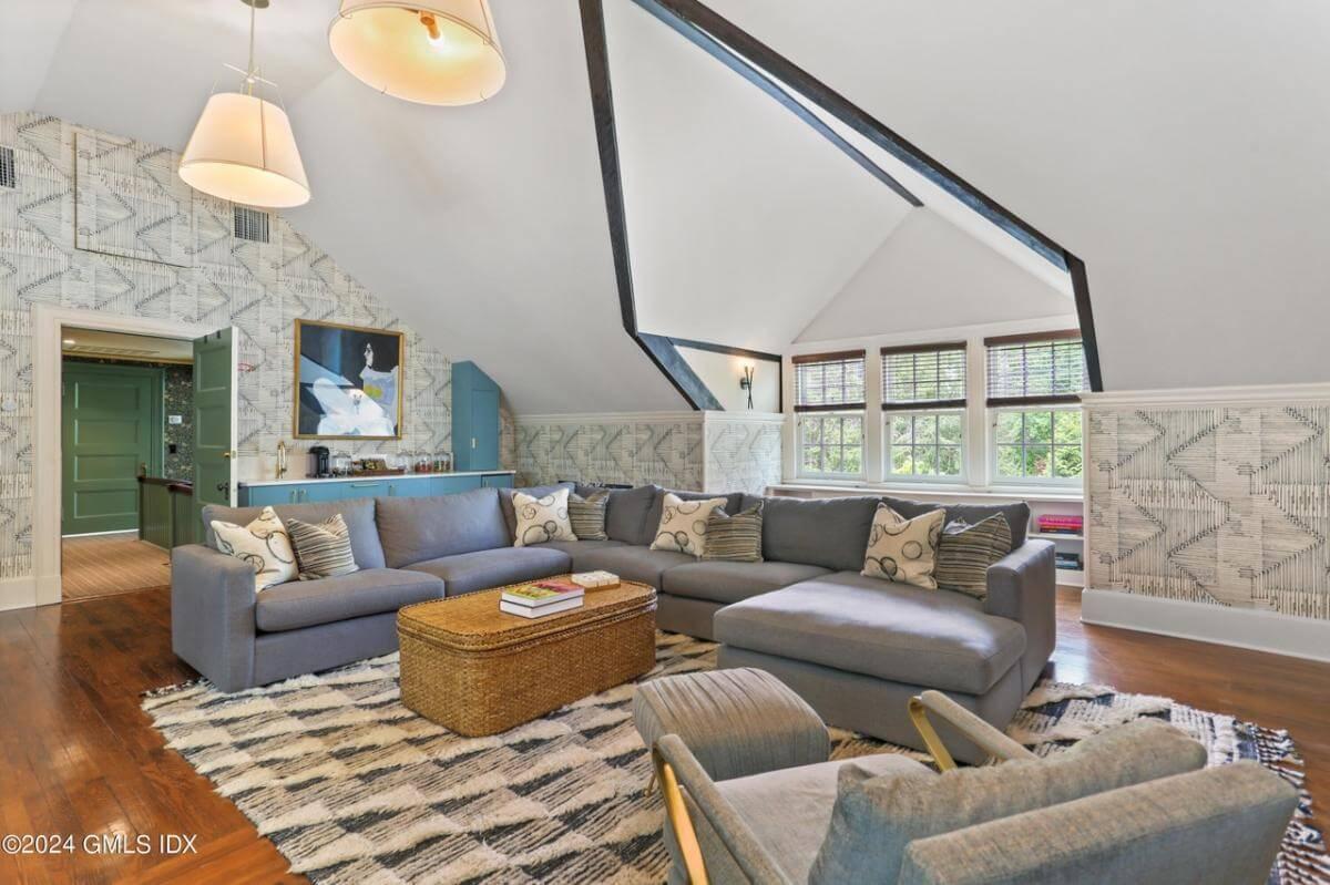 Check Out the Patterned Wallpaper Adding Character to This Cozy Attic Lounge