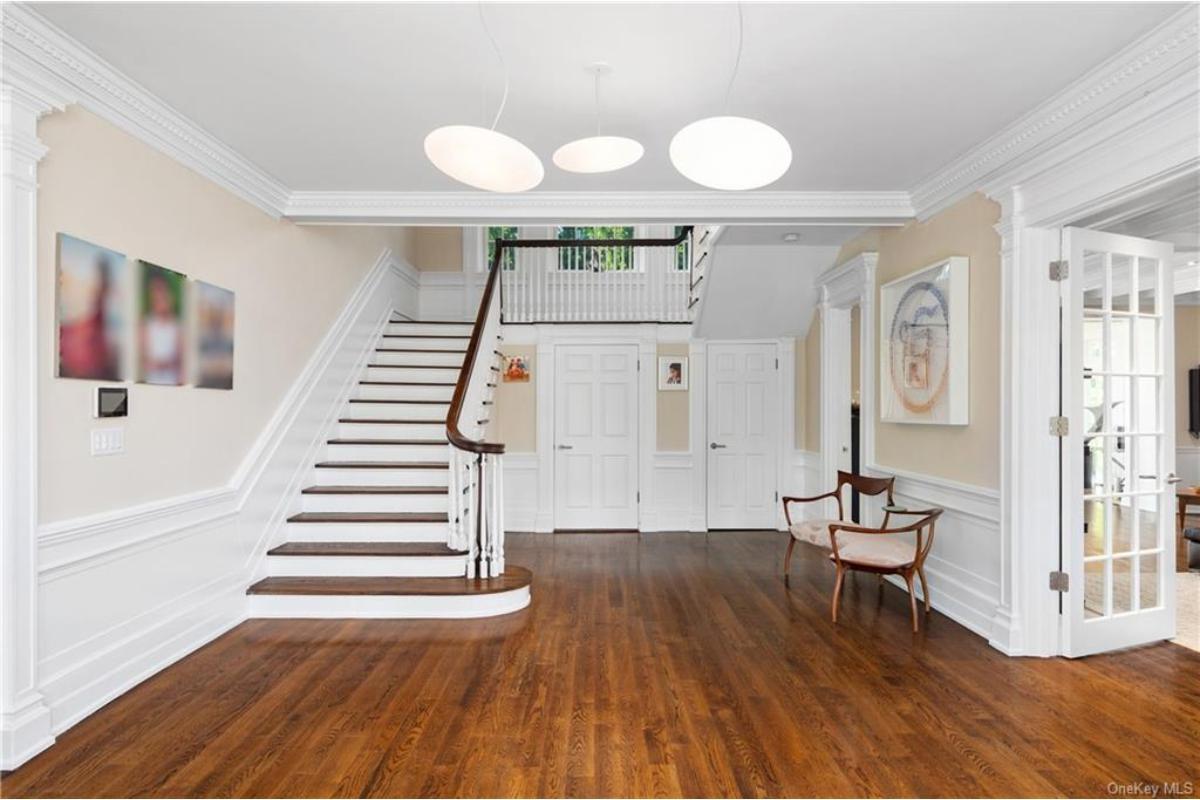 Wow, Look at the Timeless Elegance of This Grand Foyer with a Sweeping Staircase