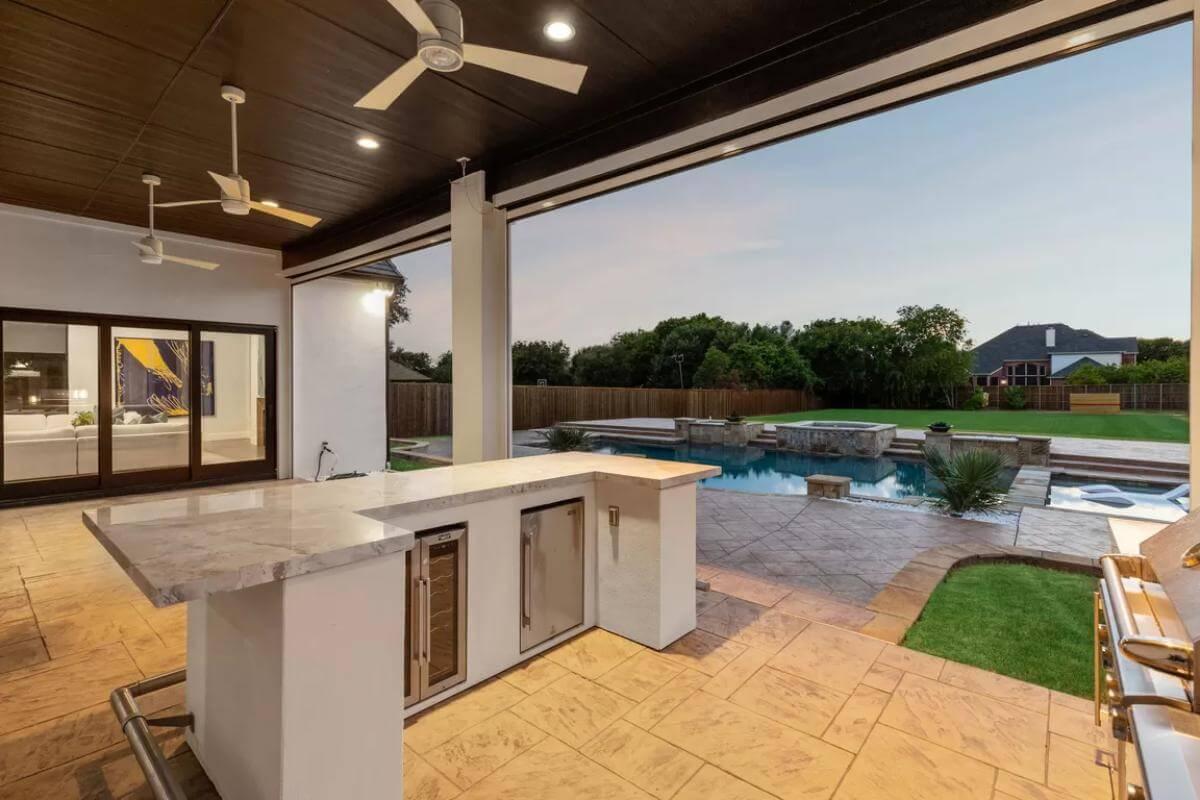 Outdoor Oasis Featuring a Sleek Poolside Kitchen Bar
