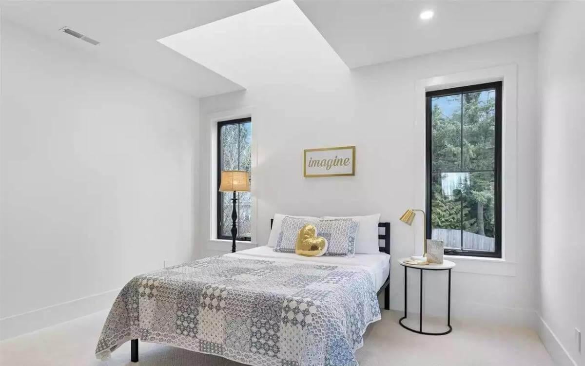 Bright Bedroom with Skylight and Cozy Quilted Bedding