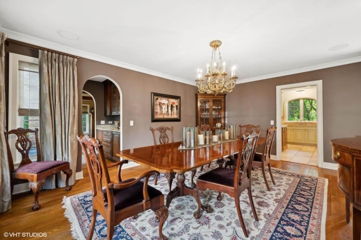 Classic Dining Room with Ornate Chandelier and Rich Wood Furniture