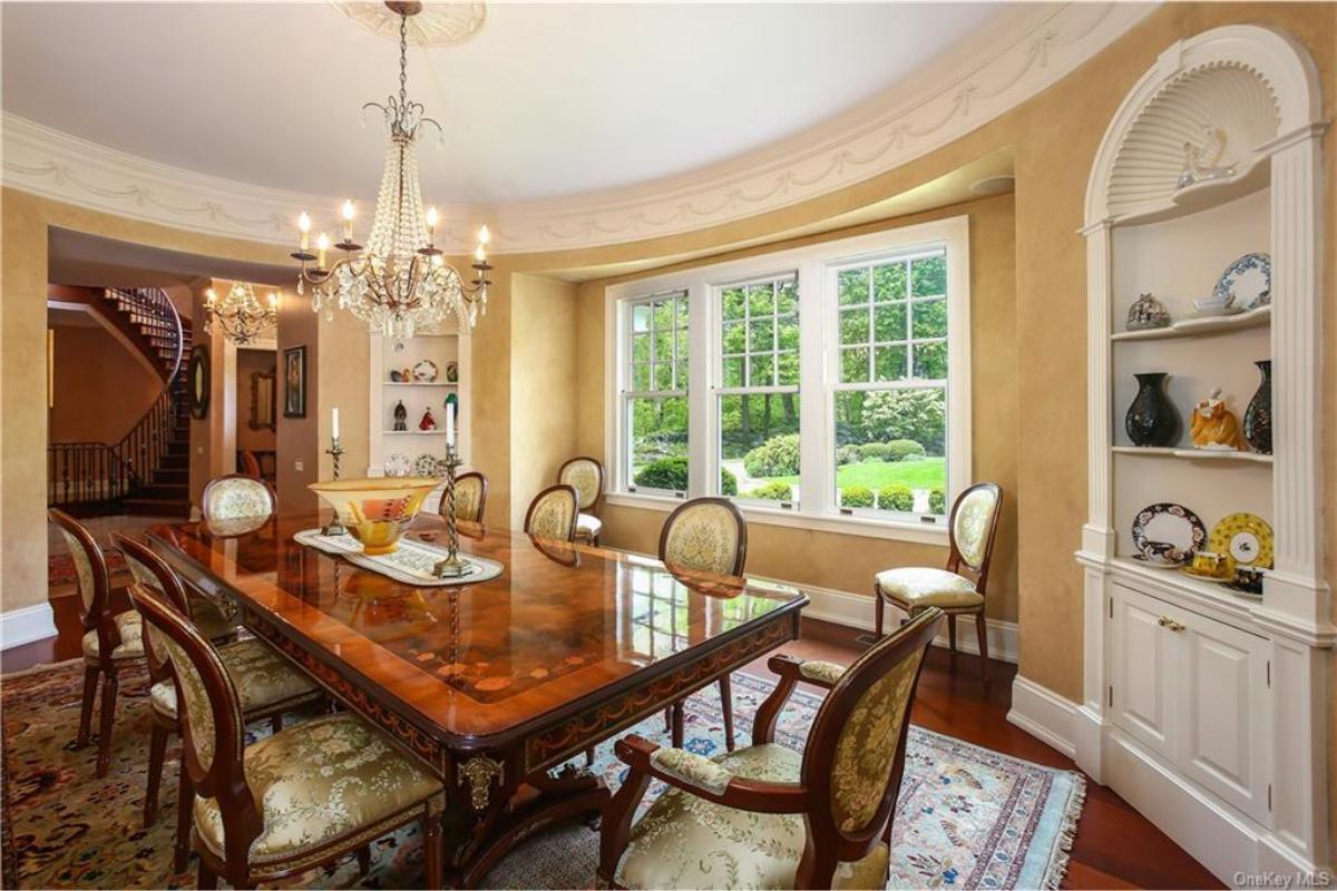 Sophisticated Dining Room with Detailed Woodwork and Expansive Bay Window