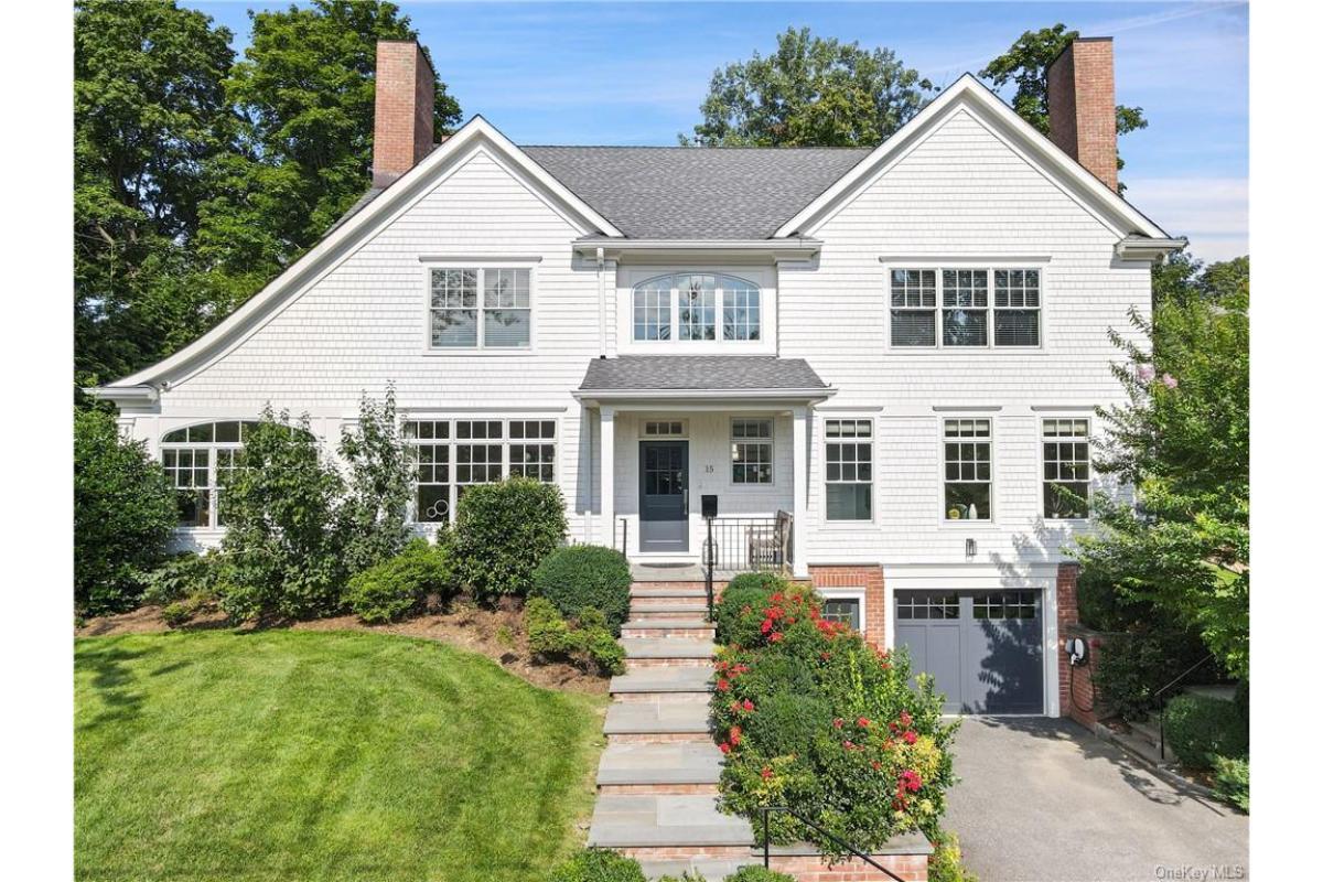 Classic Colonial with Crisp White Facade and Charming Pathway