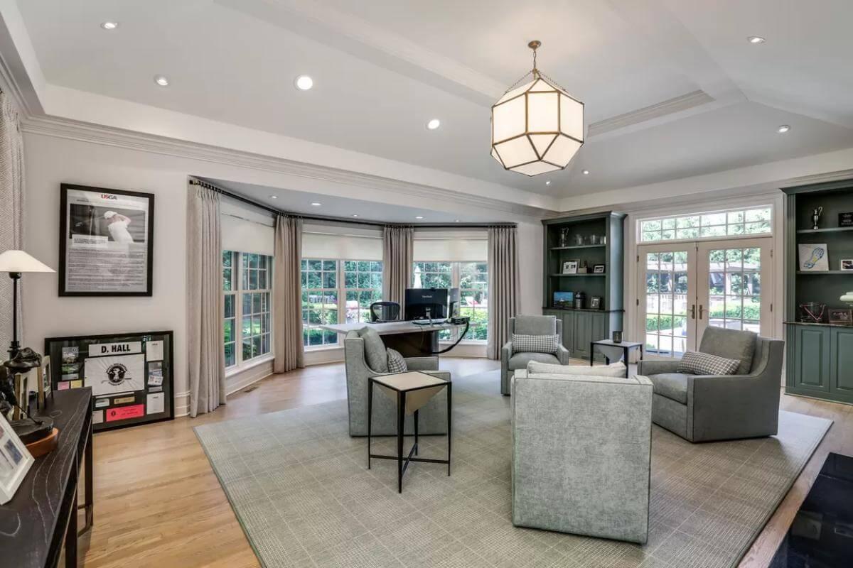A Bright Office Space with Bay Windows and Built-in Shelving