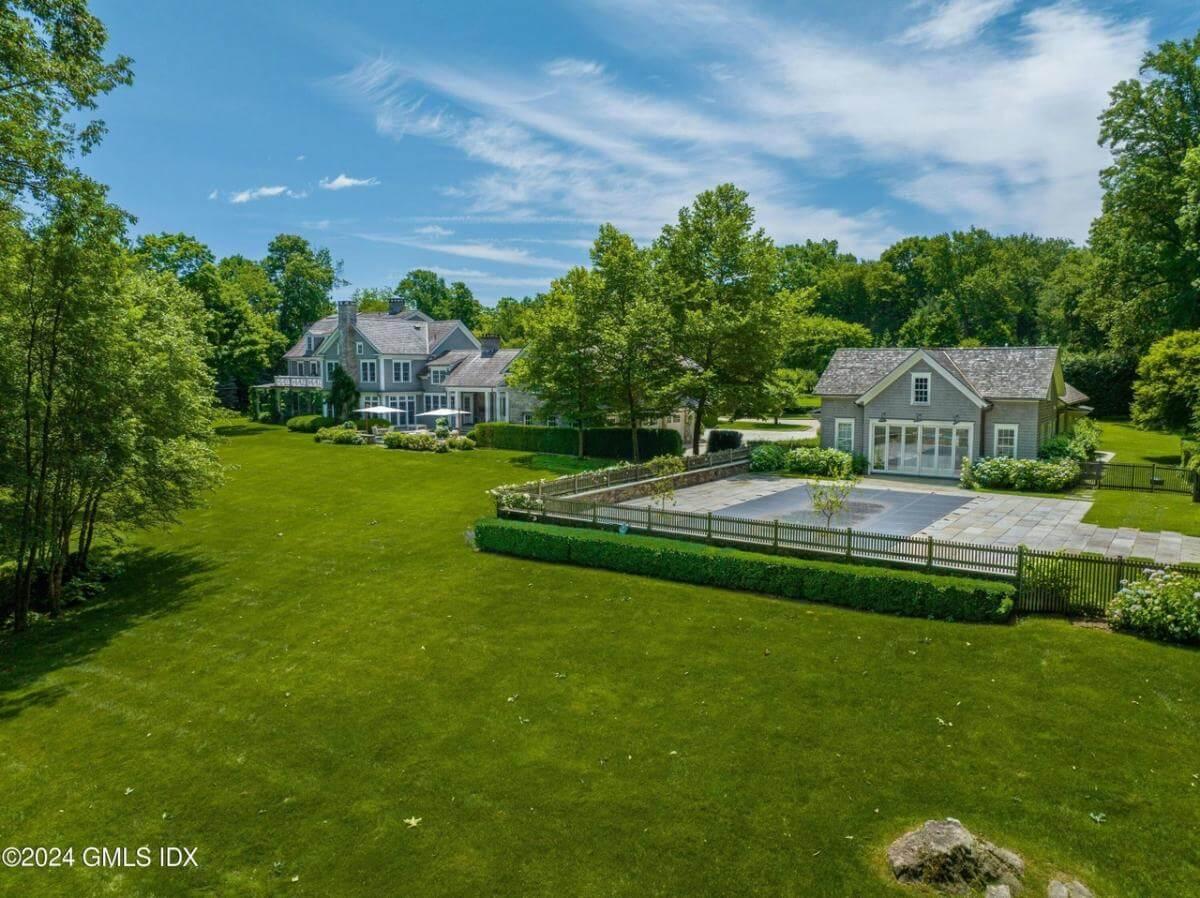 Admire the Expansive Lawn and Pool House in this Estate