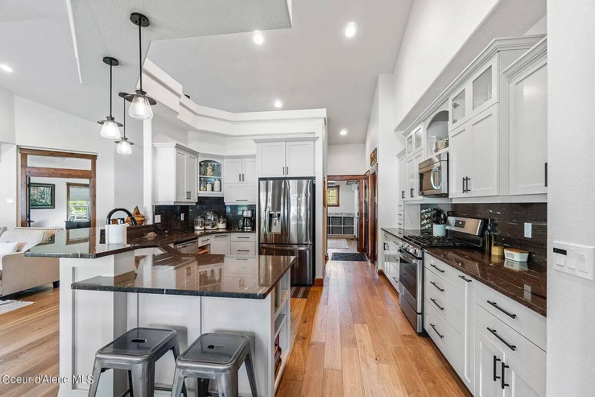 Check Out the Sleek Granite Island and Modern Lighting in This Craftsman Kitchen