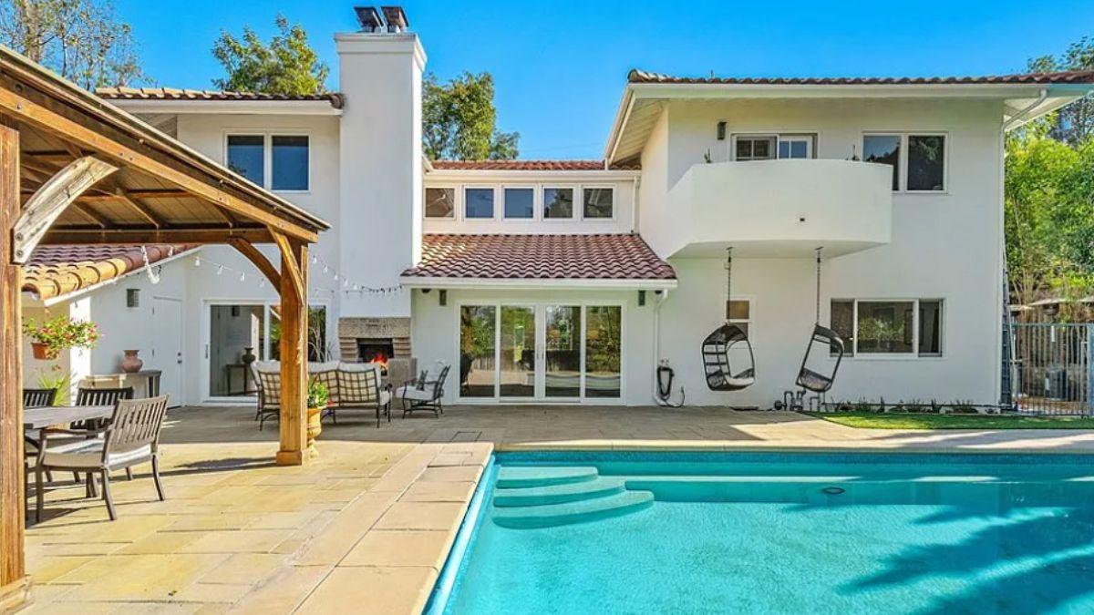 Dive into Luxury with This Backyard Pool and Cozy Swing Chairs