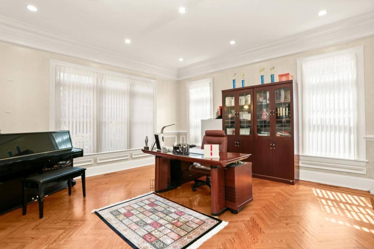 Sophisticated Home Office with a Sleek Piano and Rich Wood Accents